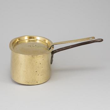 A BRASS AND CAST IRON SAUCEPAN AND COVER, 18th century.