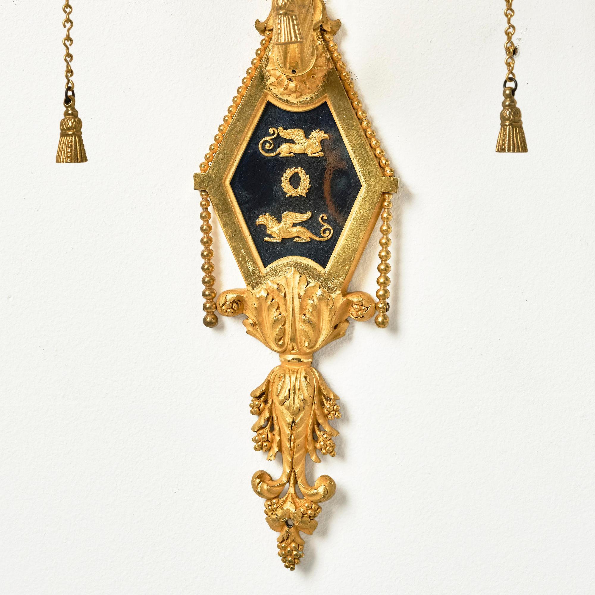A pair of two-branch late Louis XVI ormolu and blued steel appliques attr. to F. Rémond (bronzier in Paris 1774-1812).