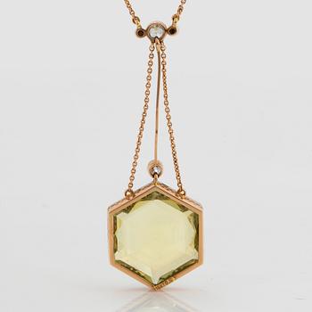 An 18K gold and platinum pendant set with a faceted beryl, old-cut diamonds and pearls.