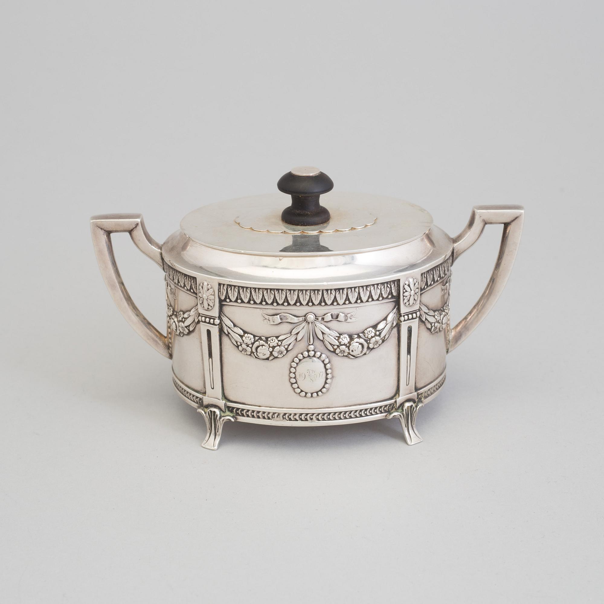 A set of three silver objects (coffeepot, creamer and sugarbowl, CG Hallberg and GAB, Stockholm 1907. Weight ca 1226 gr.