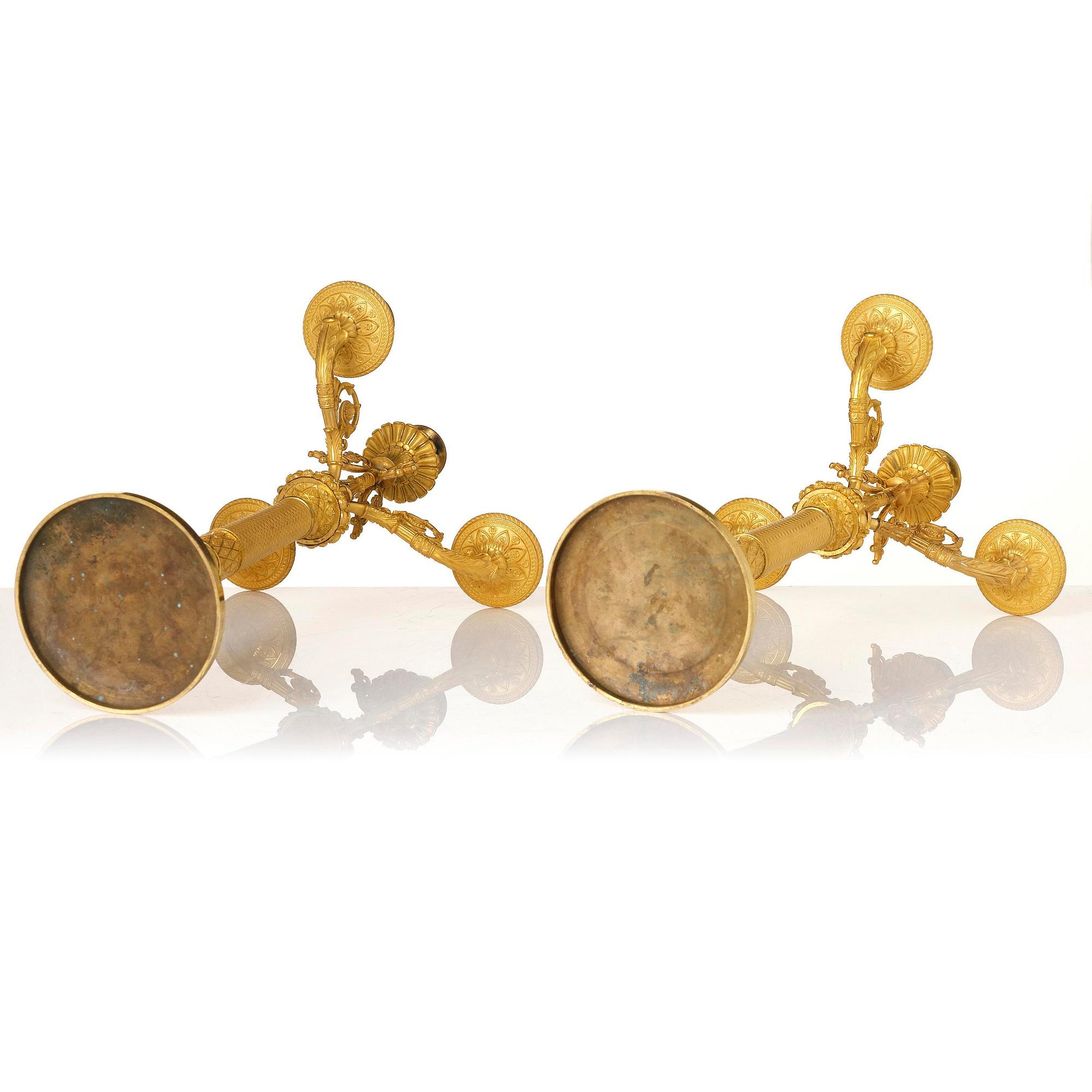 A pair of French Empire four-light gilt bronze candelabra, early 19th century.