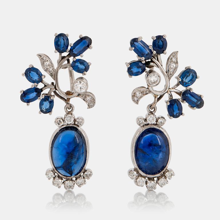 A pair of CF Carlman platinum earrings set with cabochon-cut and faceted sapphires.