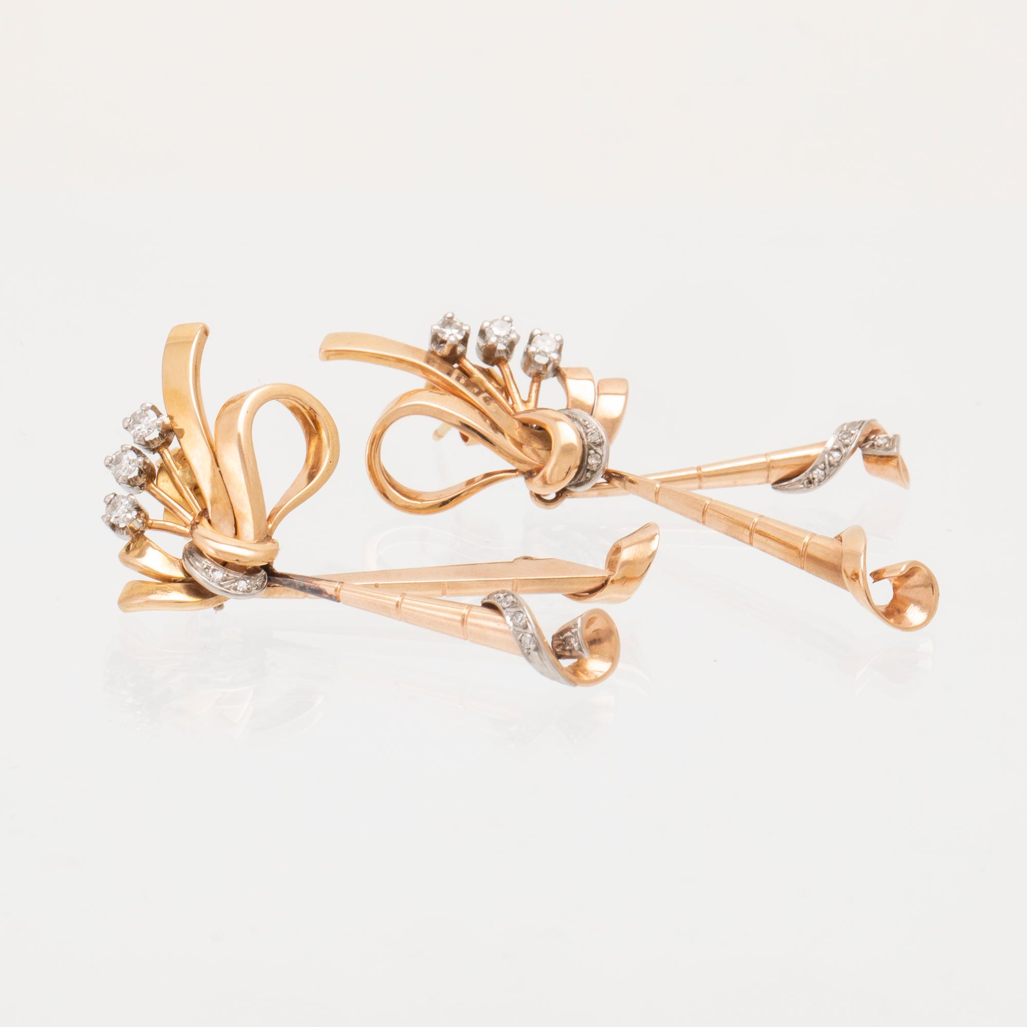 A pair of 18K white and red gold earrings set with single cut diamonds.