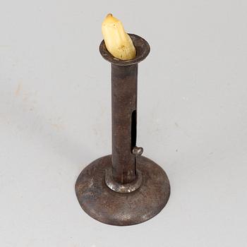 An 18th century tinplate candlestick.
