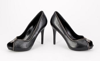 701. A pair of blck leather shooes by Alexander Mqueen.