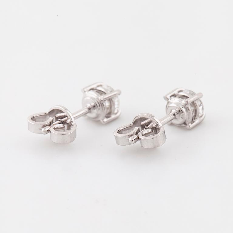 A pair of brilliant cut diamond earrings.