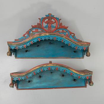 Two painted and carved wooden clothes hangers, Indonesia, 20th Century.