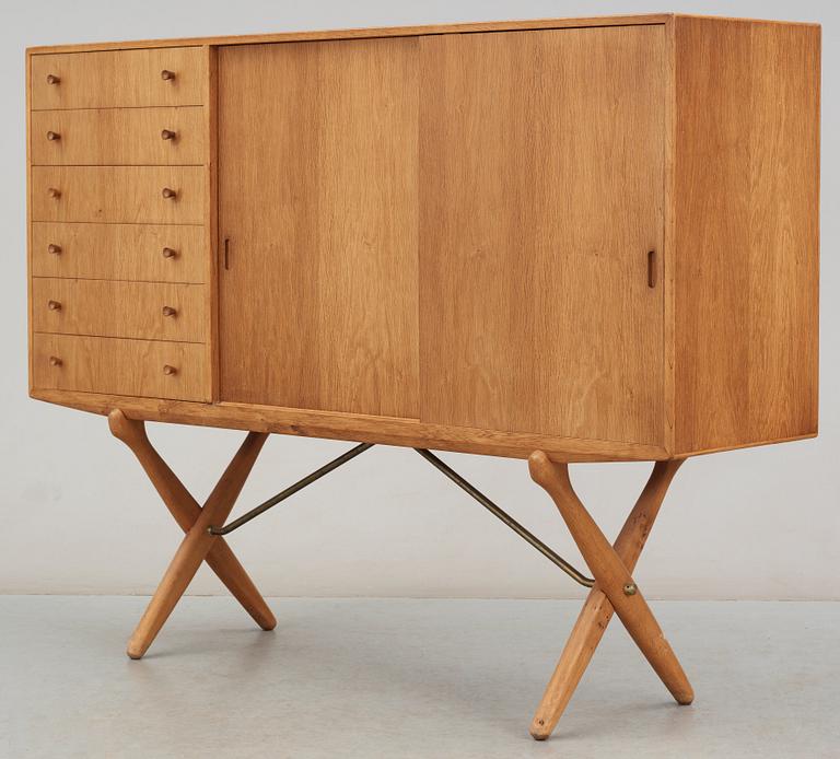 A Hans J Wegner oak cross-shaped leg sideboard by Andreas Tuck, Denmark.