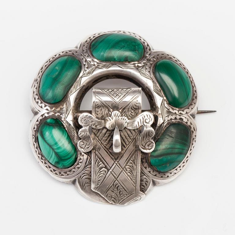 A BROOCH set with malachite.