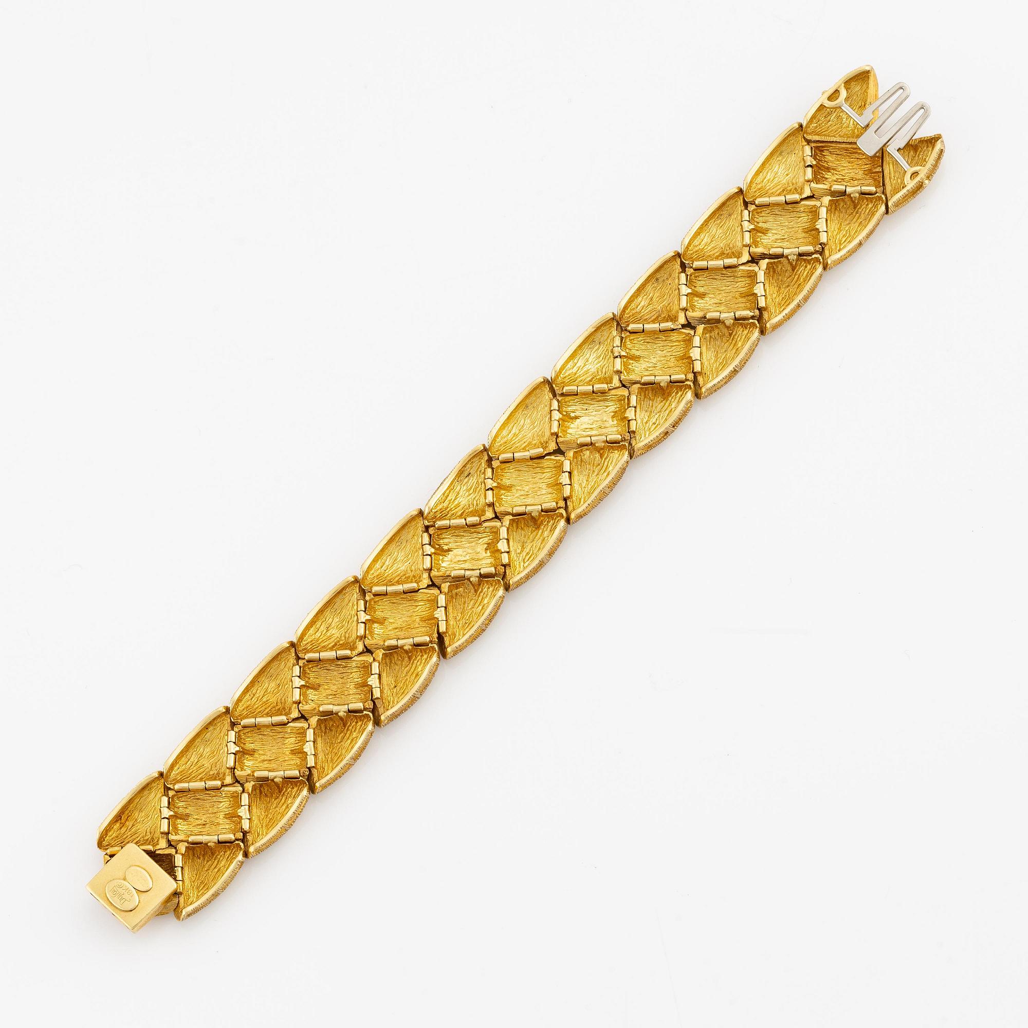 An 18K gold bracelet by Henry Dunay.
