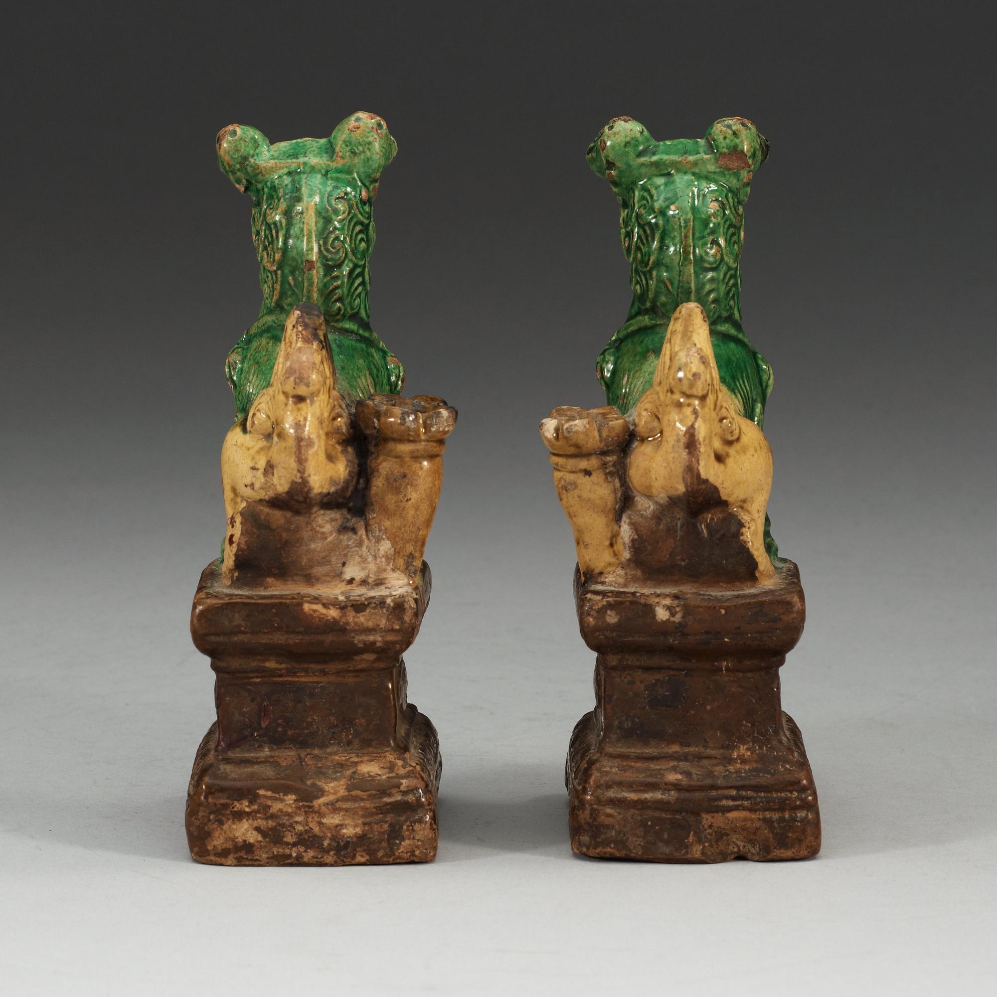 A pair of brown, green and yellow glazed joss stick holders, Qing dynasty (1644-1912).