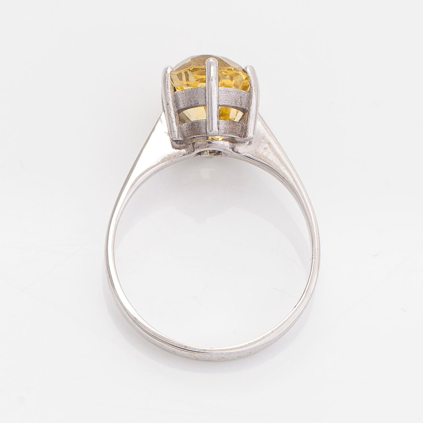 An 18K white gold ring with an oval faceted sapphire.