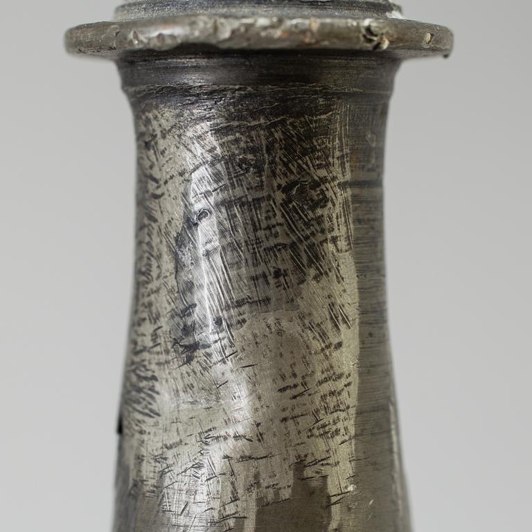 A pair of baroque pewter candlesticks, engraved date 1699.
