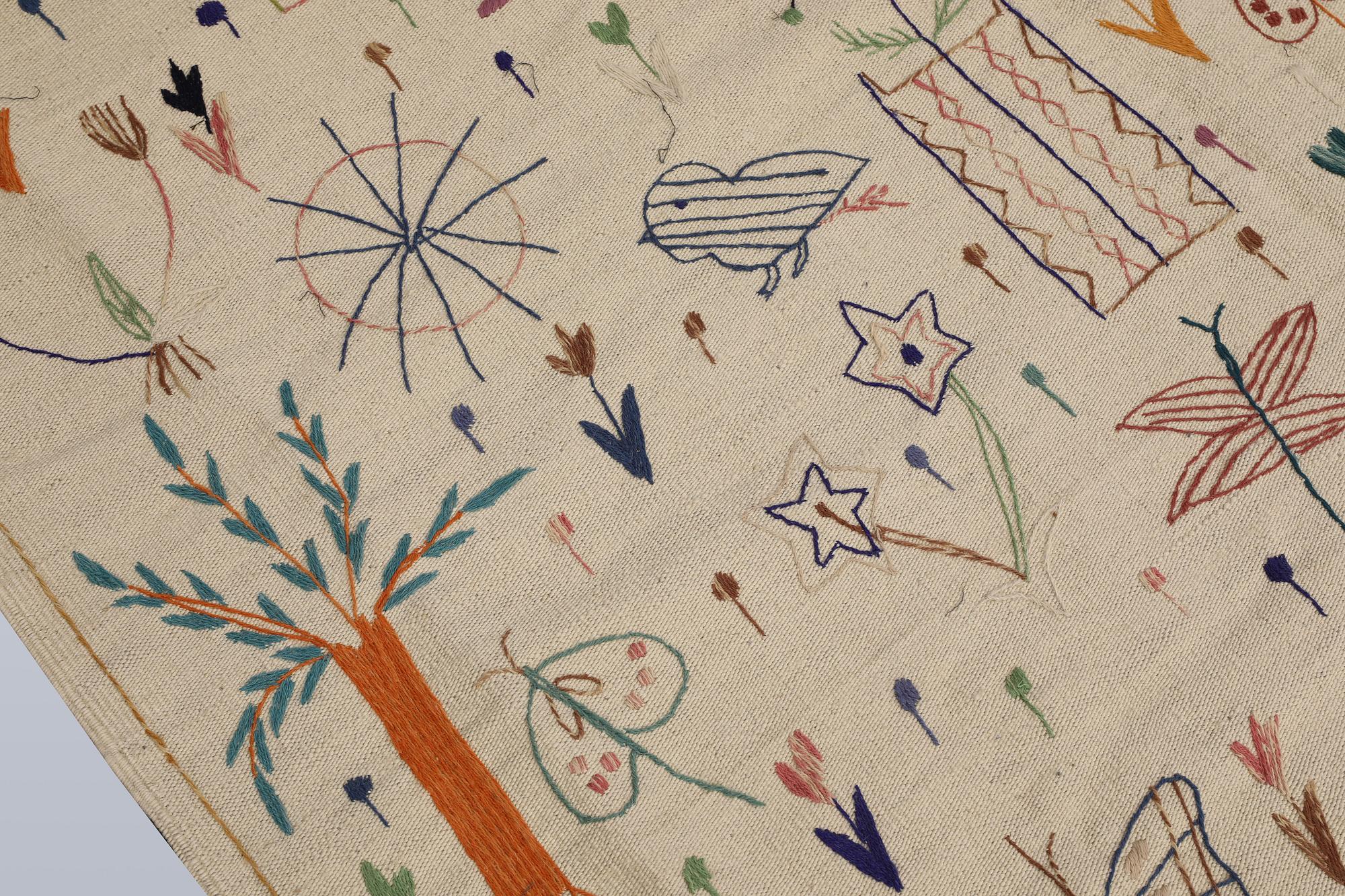 A hand-embroidered Kilim rug, approx. 244 x 180 cm.