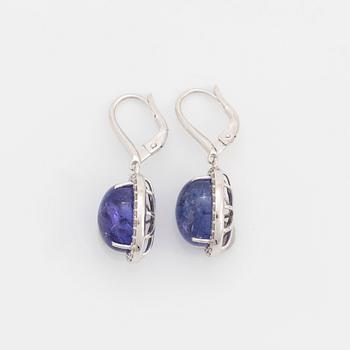 Cabochon-cut tanzanites and diamond earrings.