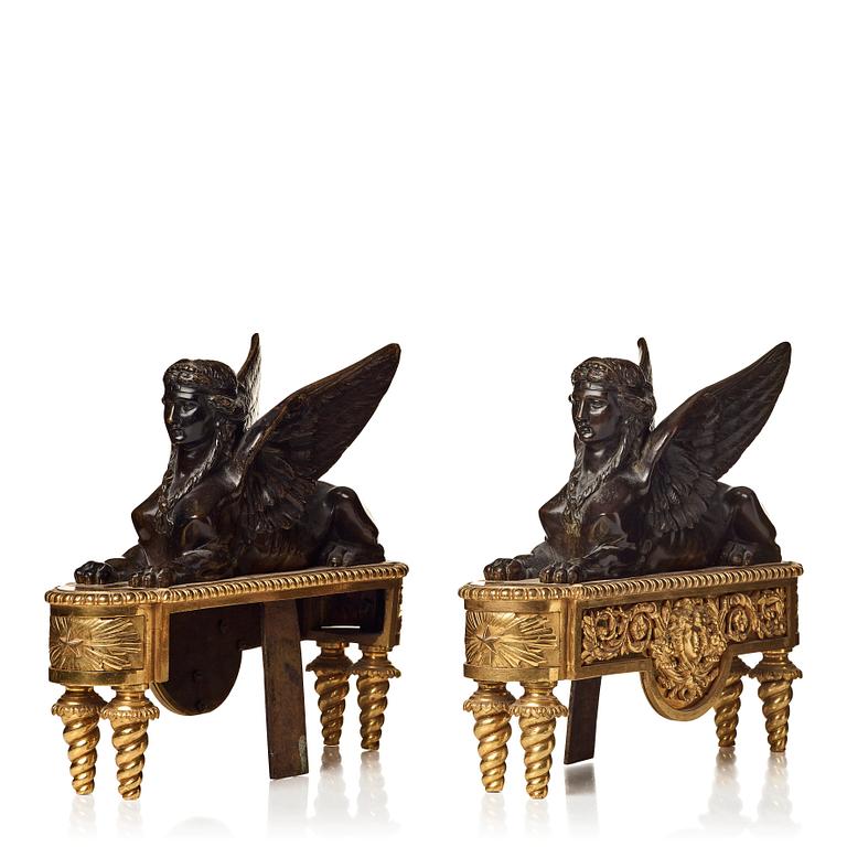 A pair of French Empire first half 19th century gilt and patinated bronze chenets.