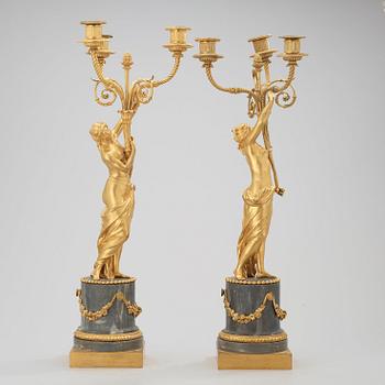 A pair of Louis XVI circa 1780 three-light gilt bronze and bleu turquin marble candelabra.
