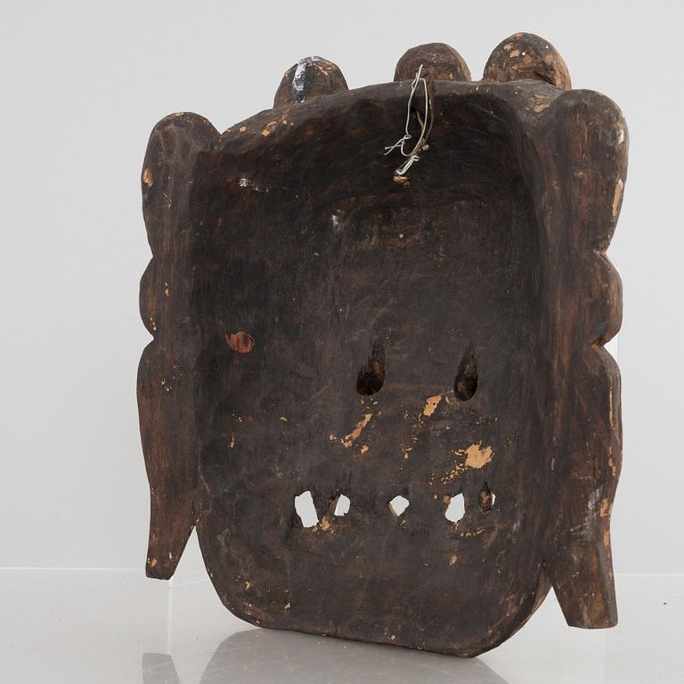 Four Tibetan/South East Asian wooden decorations, 20th century.