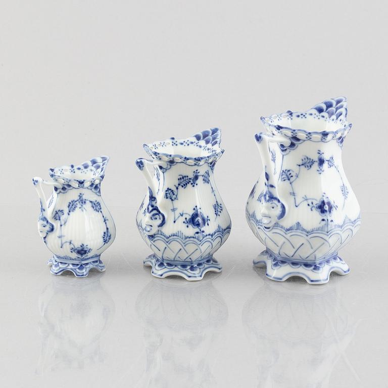 Three 'Blue Fluted Full Lace' / 'Musselmalet' porcelain creamers / jugs, Royal Copenhagen, 20th century.