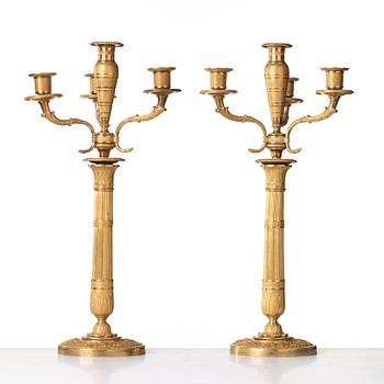 A pair of Empire early 19th century gilt bronze four-light candelabra.