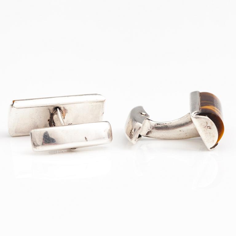 A set of three pairs of silver cufflinks with hematite, tigers eye and granite. Turun Hopea and Osvald Mättö.