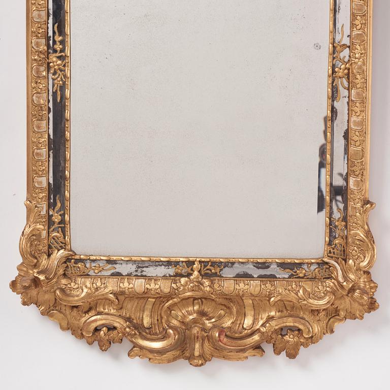 A Swedish rococo giltwood mirror, later part of the 18th century.