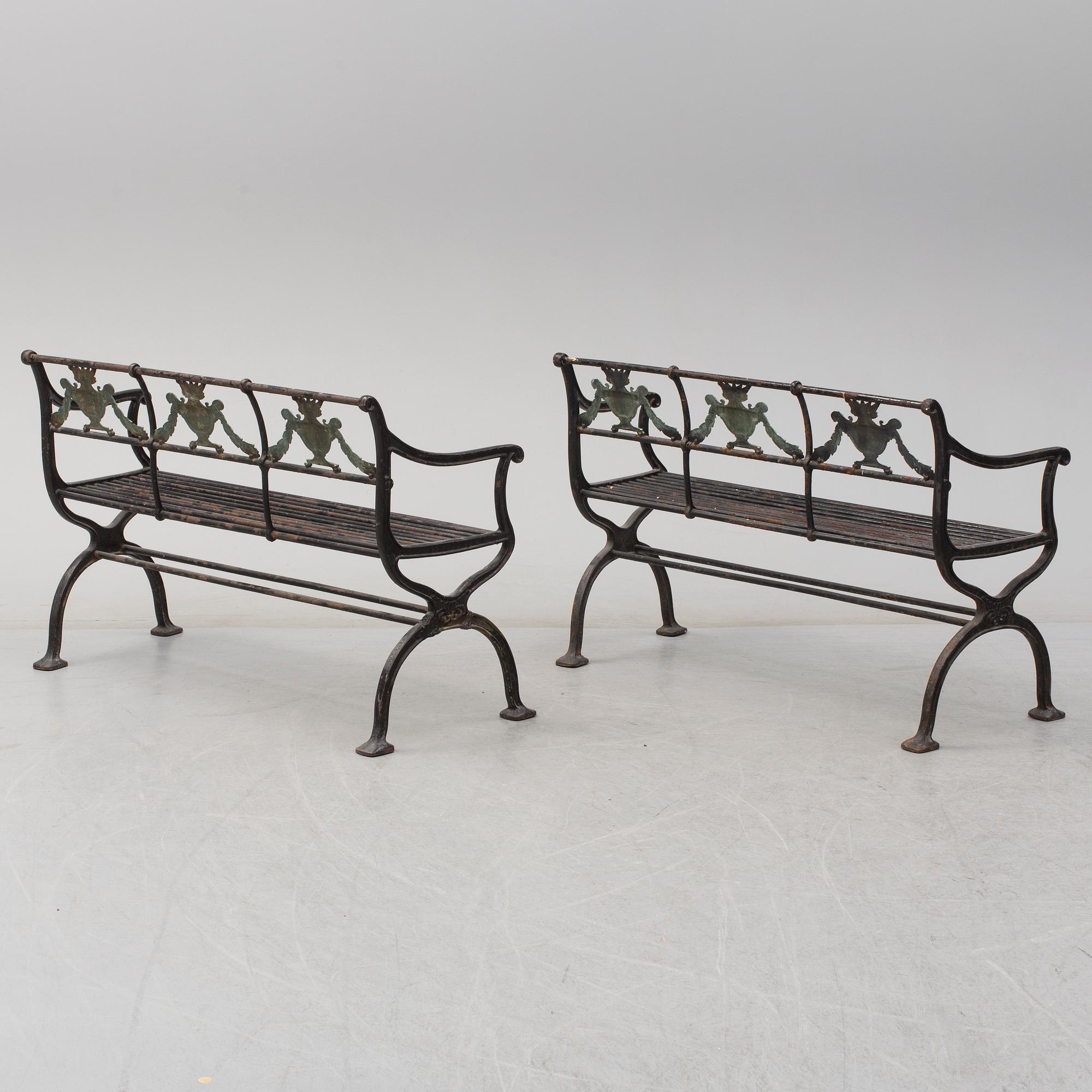 GARDEN SOFAS, a pair, cast iron, empire style, late 19th century.