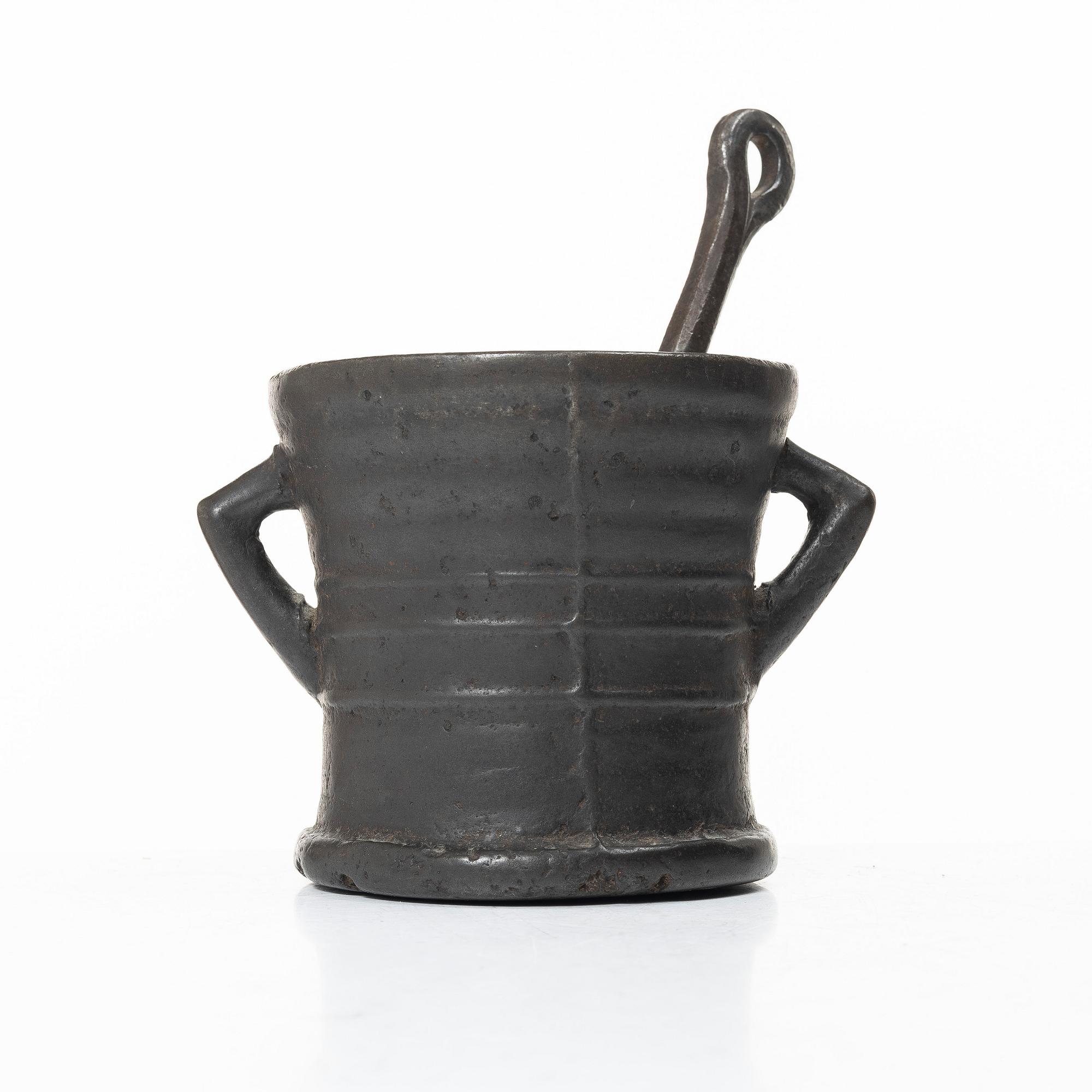 Mortar and pestle, dated 1673.