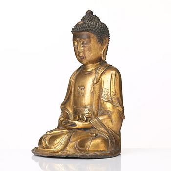 A gilt bronze figure of Amithaba Buddha, Ming dynasty (1368-1644).