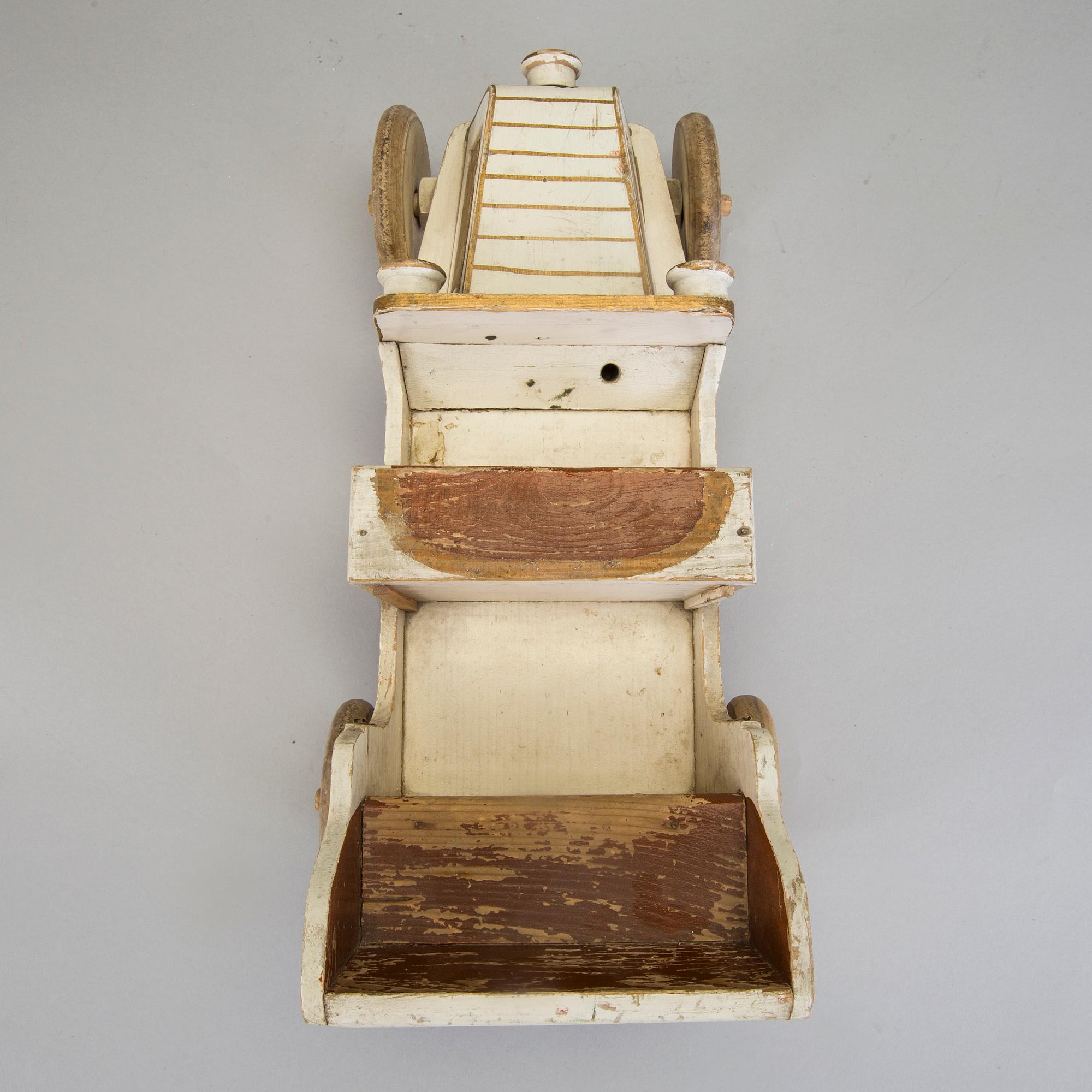 A painted wooden toy car c. 1910.