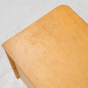 A pair of oak veneered bedside tables, mid 20th Century.