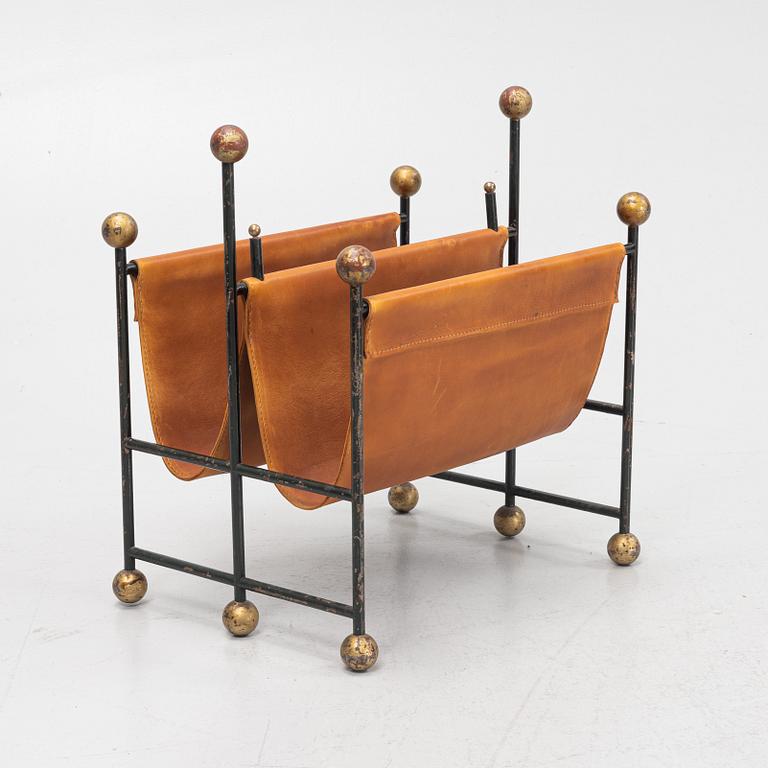 An iron and leather magazine stand. 20th Century.