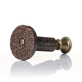 An Empire 'Blyberg' porphyry candlestick from Älvdalen, first part 19th century.