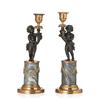 150. A pair of French Louis XVI ormolu and marble candlesticks, late 18th century.
