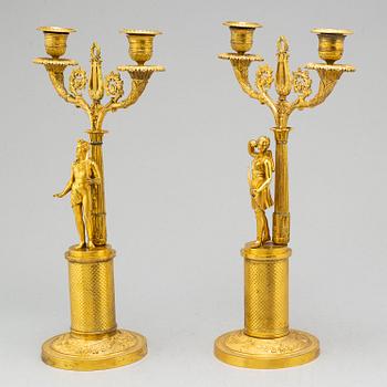 A pair of French Empire two-light gilt bronze candelabra, early 19th century.