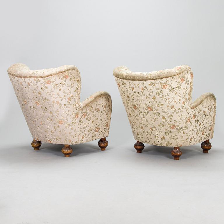 A pair of mid-20th-century armchairs.