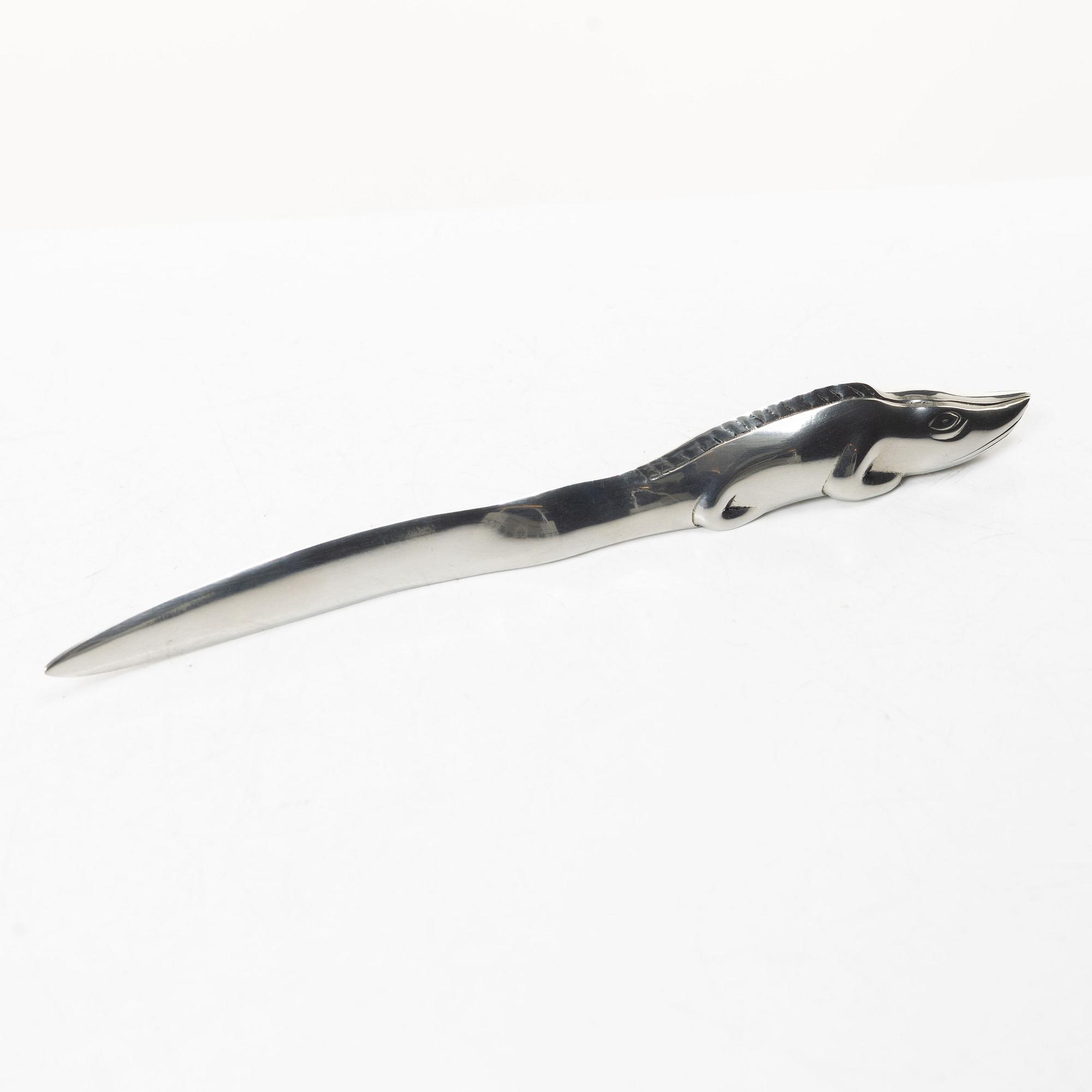 Firma Svenskt Tenn, Candelabrum, 'Vänskapsknuten', and paper knife, 'Alligator'.