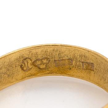 A 23K gold ring.