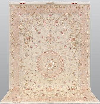 A Tabriz part silk carpet, signed, 305 x 203 cm.