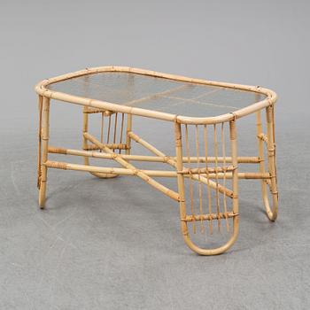 A rattan and glass table and a rattan sofa, second half of the 20th century.