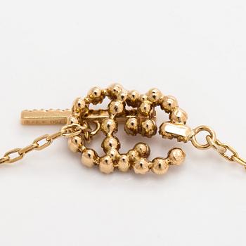 Gucci, an 18K gold 'Interlocking' bracelet with brilliant-cut diamonds.
