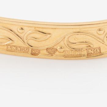 Arm ring, 18K gold with stylised decoration.