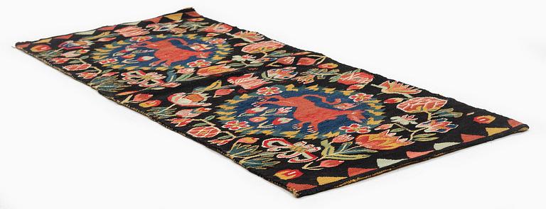 A cushion, 'Red Lion' (Rött Lejon), tapestry weave, c. 102 x 46cm, southwestern Scania, first part of the 19th century.
