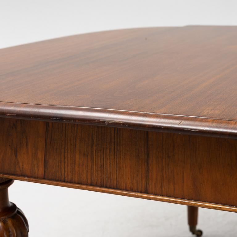 A walnut veneered dining table, probably England, late 19th Century.