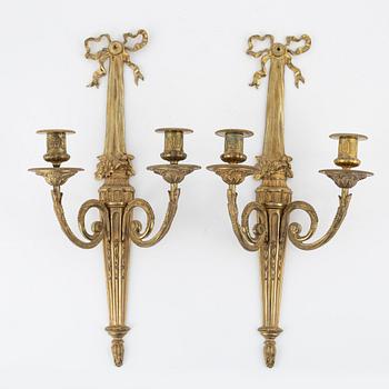A pair of gilt brass wall sconces, Louis XVI-style, early 20th century.
