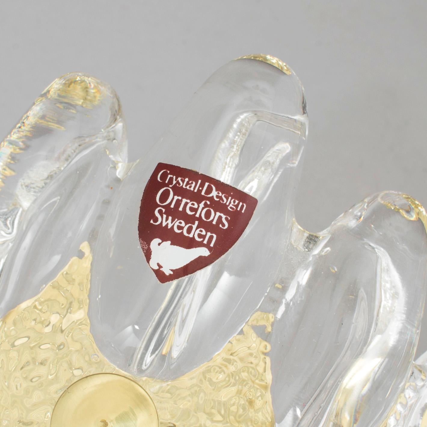 A pair of brass and glass wall lights designed by Carl Fagerlund for Orrefors.