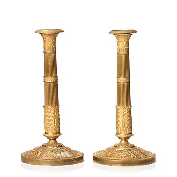 127. A pair of French Empire early 19th century candlesticks.