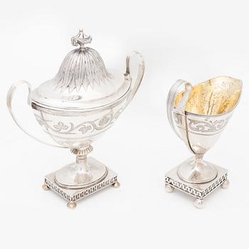 A silver sugarbowl with lid and a creamer, marks of Olof Hellbom, Stockholm, Sweden 1799-1800.