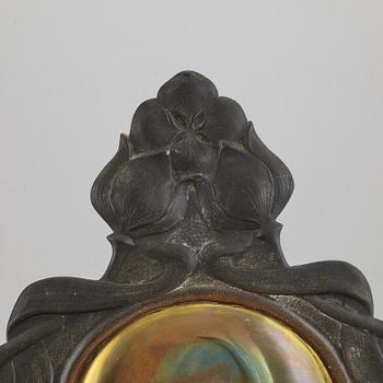 A pair of bronze and brass wall sconces from the early 20th century.