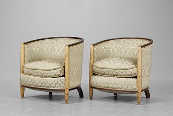 A pair of French partly gilt palisander armchairs in the manner of Poul Follot, 1920-30's.